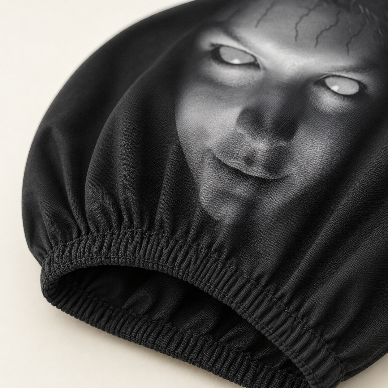 Close-up of the black polyester fabric and gathered elastic opening on a ScareSeat cover
